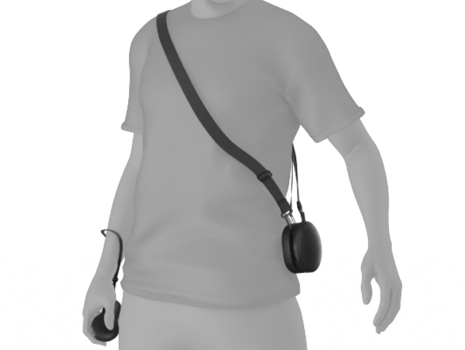 A person wearing their Magic Leap 2 compute pack with the shoulder strap worn over their shoulder like a messenger bag