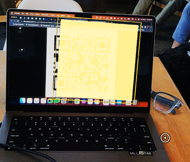 A yellow box appearing over the QR code as the scanner app reads the code